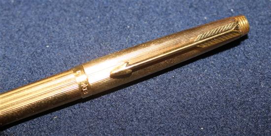 A 1930s 9ct gold Watermans Ideal Junior fountain pen and two gold plated Parker pens.